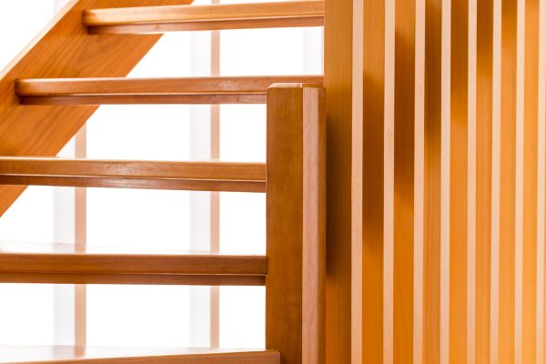 Indoor wooden staircase with light behind it